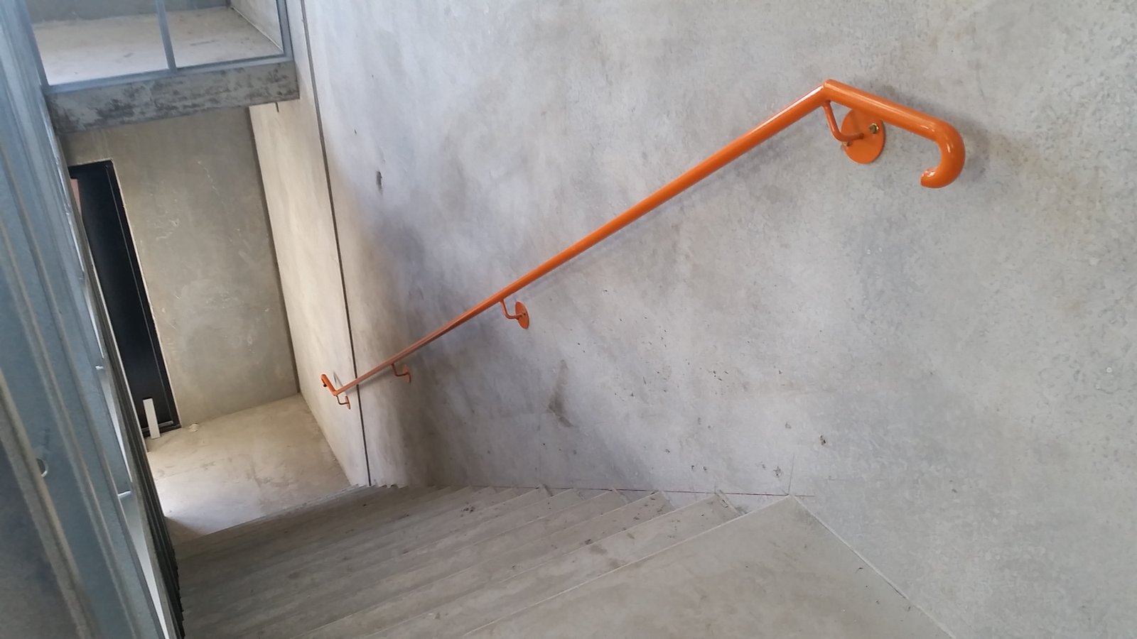 Orange stair handrail installation